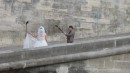 Bride being photographed on Paris bridge.