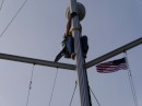 Neil climbing up the mast. You can also see our courtesy flag.