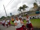 The Samoan girls wear skirts with their school logo that fall past their knees and shirts with sleeves. 