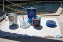 Required components for successful varnishing: mixing cup, foam brush, high quality varnish (e.g. Epifanes), blue tape, and naphtha solvent.  You also need low/no wind, no rain and some drop cloths to protect the gelcoat.  A solvent soaked rag is handy to have nearby as drips are inevitable.