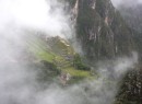 View from Wanu Picchu of a mist covered mythical Manchu Picchu