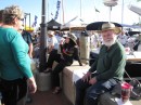 Lin and Larry Pardey sign books talk with folks and sign books near their booth at the boat show.