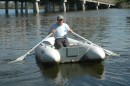 Robert rows off to the boat ramp to remove the bay life from the bottom of the dinghy.