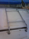 New stainless steel rack I had made. It will take the weight of the emergency liferaft and keep it of the hatch garage.