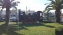 Old steam train on a small roundabout.