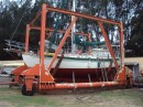 This shows active transport in the travel lift.  This is not a self propelled travel lift like others we have been hauled with.  The lift is lowered into the water using a farm type tractor and the boat is lifted into the frame of the lift using 4 chain hoists at each corner.  They left us in the hoist as it costs less that propping the boat up on land.