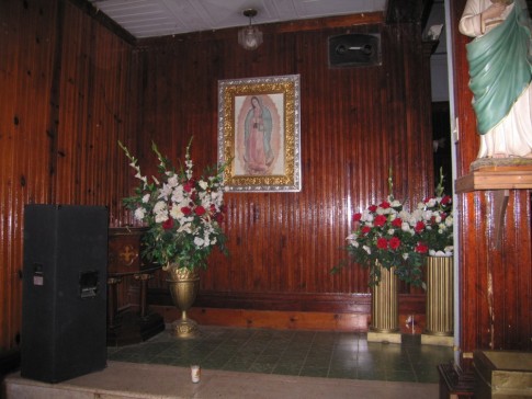 Here is a shot of the requisite lady of Guadalupe picture in a niche in the church.  Note the bose speaker set in the wall above the pic.  Nothing but the best for jebus