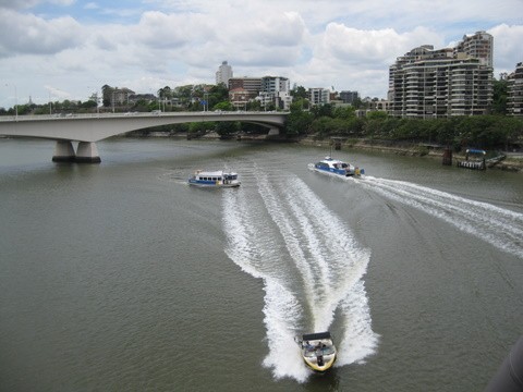 There are lots of boats that move up and down the river.  This pic shows a couple of the types of ferries and a private speed boat.