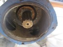 this view of the two ports of the pump show how the metal bar across the right hand port  that was intended to prevent impeller damage, when the vanes ran past the edges of the open port, in completely broken.  The one on the left was thin and distorted but that does not show up too well in the photo.  The blue stuff was RTV gasket material that I attempted to use to help seal the new plate we had made.
