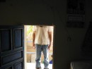 Here is the door to our room.  That is shawn on the other side.  john could not get into the room without removing his backpack first.  Our assumption was that the adobe walls could not support the roof if they cut a full height door in the wall. 