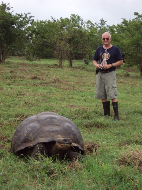 Here is John with one of the giant tortoises.  Please note the extremely stylish boots provided by the tourist operation for use when stomping around out in the field with the tortoises.  