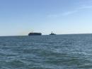 Container ship and naval ship pass by: Hampton