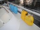 Jerry Jugs on the Rail: The blue jug holds water. The yellow one holds diesel fuel.