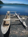 Traditional dug out canoe on the shore of the crater lake.