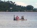 locals enjoy an afternoon of fishing on their home-made raft