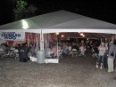 Participants gather for a "last supper" under the rally tent at the Blue Water Yachting Center.