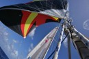 Tensioned sheets, stays, and sails create a study in harnessed energy and vector forces.