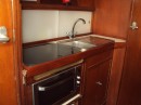 Galley area - new cupboards and shelves, new fomica top, new acrylic sliding doors to lockers, new 3 burner gas cooker top and sink / topas, plus inverter powered  220v microwave / convection grill and oven.