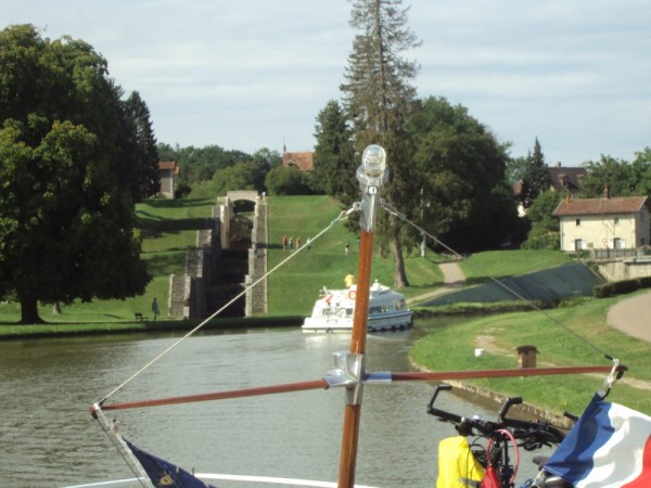 Leaving the first of the six modern locks at Rogny (pronounced Ronny) - with the ancient seven lock series as seen behind Sue