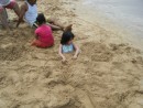 Their favorite beach activity...to cover each other in sand.