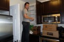 Mike can reach the top cupboards (on a stool).