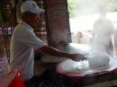 Rice noodle factory: The batter is then spread evenly over the surface of the cloth and then covered to steam.