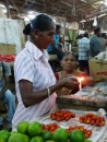sealing small packages of food with a candel in the Labasa Market