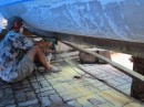 The new keel has been laminated to the hull and is being trimmed to shape. The wood for the keel is takien-tong, a very good boat building wood used now that all the teak is gone. When freshly cut it is a green-yellow which oxidizes to a dark brown after a few days.