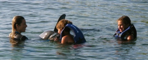 Kids w/trainer and dolphins 
