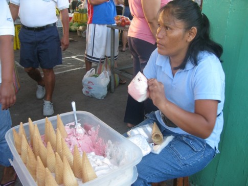 Ice cream being put in a bag and sold at fresh market