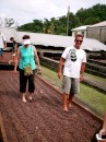Cheryl and Tom helping to dry the cocoa beans in traditional way