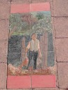 numerous pieces of art in the tile walkway done by residents