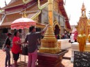 Wat Phro That Doi Suthep: Worshiper placing a flower garland on a chedi.