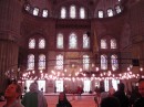 Blue Mosque: Stained-glass windows really make it breathe-taking.  Virginia in her shawl-covered head at bottom.