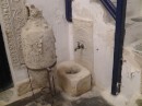 Faucets built into the walls in numerous rooms of the house.  In these towns, plumbers would have to be masons too.