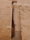 Siracusa: Ancient column preserved within a newer brick wall.