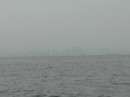 barely see the skyline of Singapore across the hazy channel