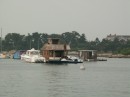 A house boat with 2 speed boats in Wood
