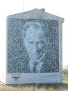 Photo of Ataturk on side of building in Gallipoli. Closer inspection shows it is actually an accumulation of many smaller photos of him.