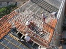 Men replacing roof tiles ... very steep slope with no safey gear.  Yikes!!