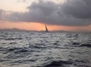 Passing yacht against setting sun near Trial Bay.