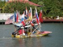 A fruit & veg boat, decorated with international flags 