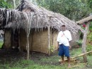 Addis Jack standing by the house he built for his daughter, Epi