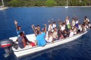 Motor boat crowded with school children stopped beside us