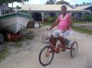  Ahe, Tenukupara; Adult cycling a tricyles