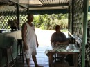 Don with server at Snack Make Make in Hiva Oa ordering our $20.00 hamburger!