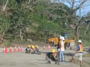 New road going in, the guys sitting on the ground are preparing the surface for tarmac with small wire brushes (like you use for removing rust)