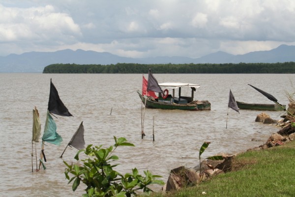 Local fishing boat with prayer flags in foreground
