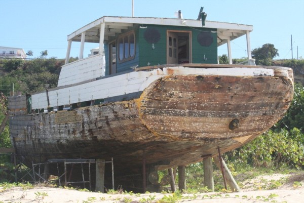 Nice old ship being slowly renovated by someone living aboard while they do it. You can see pit dug in sand where it was floated out and now propped up.