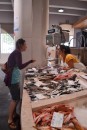Emma buying seafood at the local market